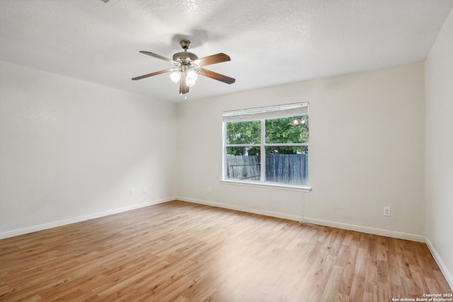 spare room featuring light hardwood / wood-style floors, a textured ceiling, and ceiling fan