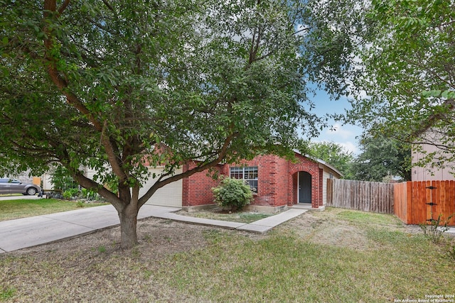 view of front of property with a garage and a front lawn