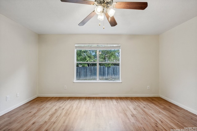 empty room with light wood-type flooring and ceiling fan