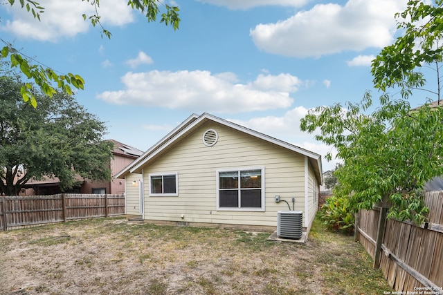 back of property with central AC