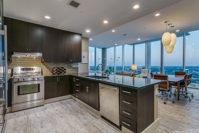 kitchen featuring hanging light fixtures, kitchen peninsula, sink, and stainless steel appliances