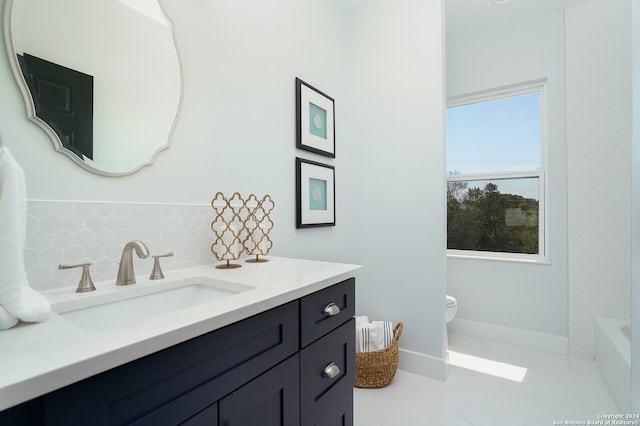 bathroom featuring decorative backsplash, toilet, a bath, vanity, and tile patterned floors