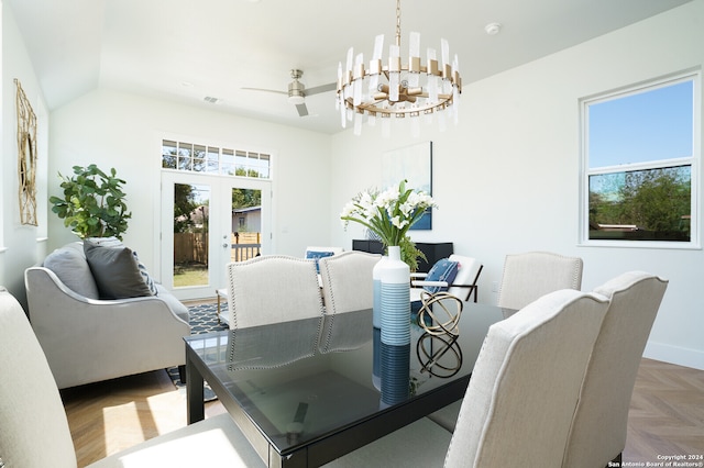 dining room featuring french doors, parquet floors, lofted ceiling, and plenty of natural light