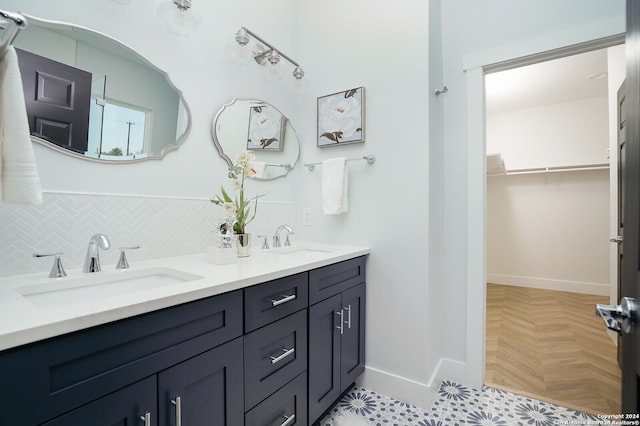 bathroom featuring backsplash, vanity, and parquet floors