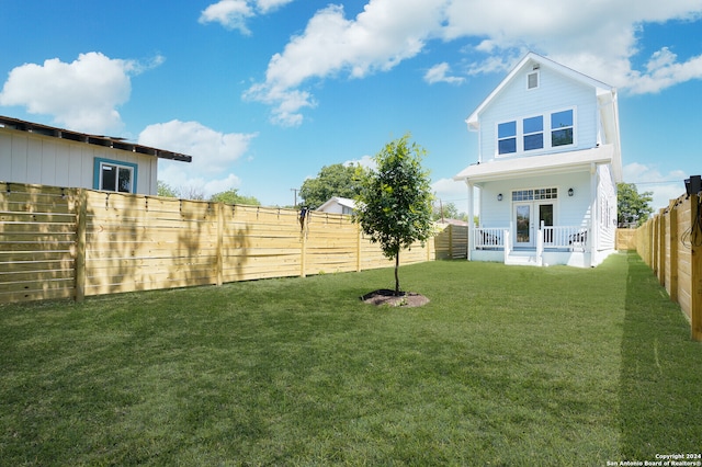 view of yard featuring covered porch