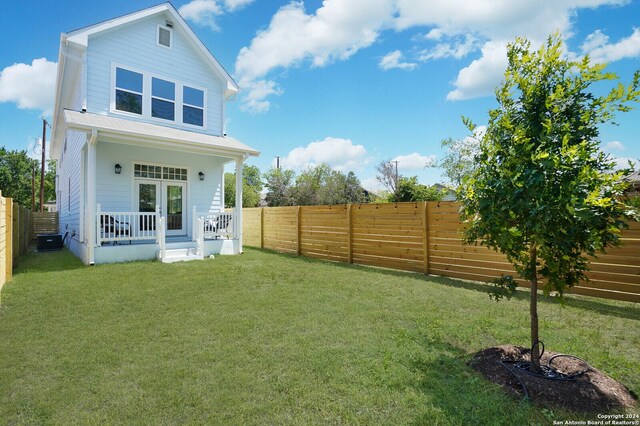 244 Porter St, San Antonio, TX 78210 - back of property with a lawn, covered porch, and a fenced backyard