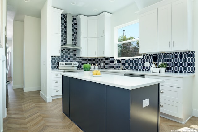 kitchen featuring electric range, wall chimney range hood, white cabinetry, and tasteful backsplash