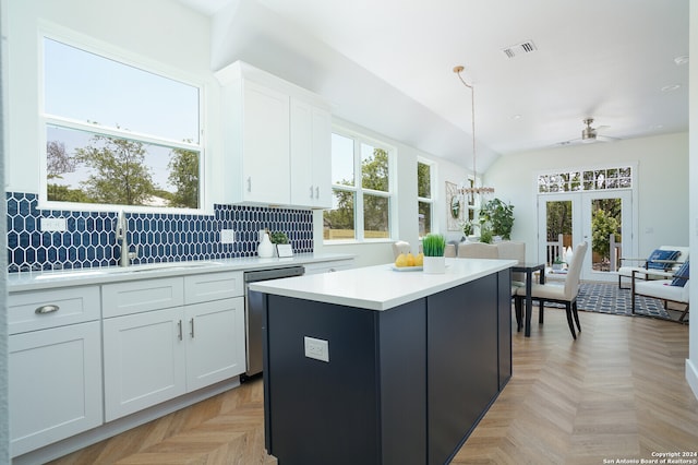 kitchen featuring white cabinetry, a healthy amount of sunlight, and pendant lighting