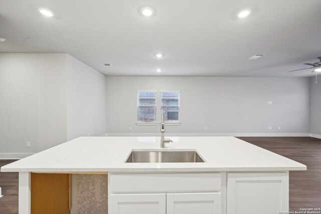 1327 Larkspur Pass, San Antonio, TX 78245 - kitchen featuring sink, ceiling fan, a kitchen island with sink, dark hardwood / wood-style floors, and white cabinets