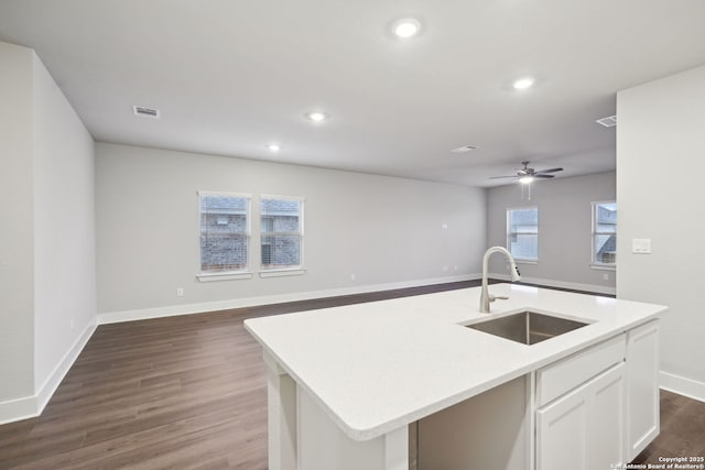 1327 Larkspur Pass, San Antonio, TX 78245 - kitchen featuring sink, dark hardwood / wood-style flooring, ceiling fan, a kitchen island with sink, and white cabinets