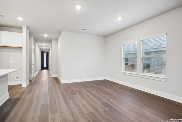 1327 Larkspur Pass, San Antonio, TX 78245 - spare room with built in desk and hardwood / wood-style floors
