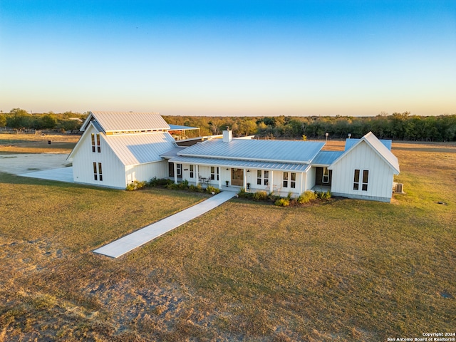 modern inspired farmhouse featuring a lawn