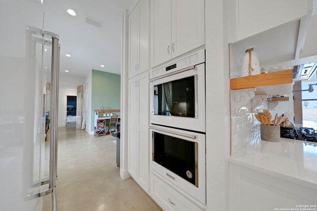 kitchen with white cabinetry and white double oven