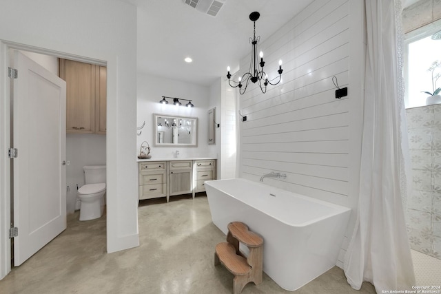 bathroom with concrete flooring, toilet, a bathing tub, vanity, and an inviting chandelier