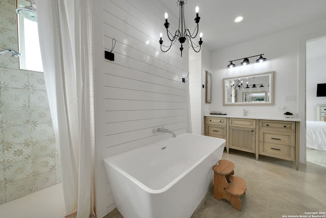 bathroom featuring vanity, a notable chandelier, and separate shower and tub