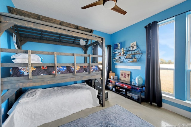 bedroom with concrete floors and ceiling fan