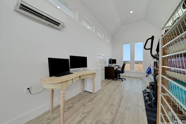 office space featuring lofted ceiling, a wall mounted AC, and light wood-type flooring