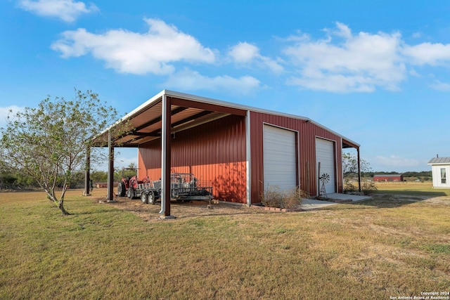 view of outdoor structure with a garage and a lawn