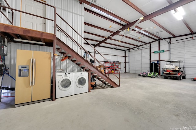 garage with washer and clothes dryer and refrigerator with ice dispenser