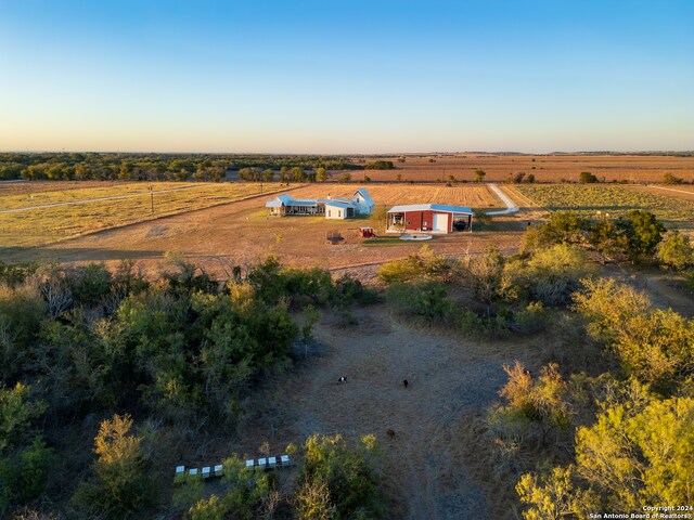 aerial view at dusk featuring a rural view