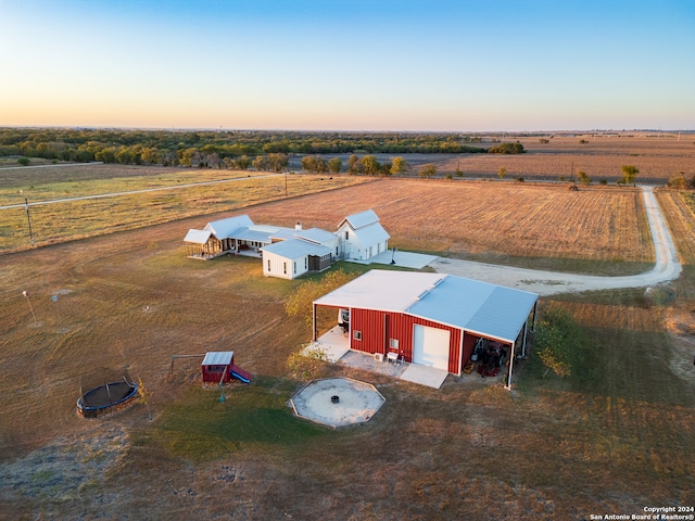 aerial view at dusk featuring a rural view