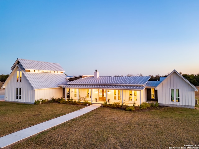 modern inspired farmhouse featuring a yard and a porch