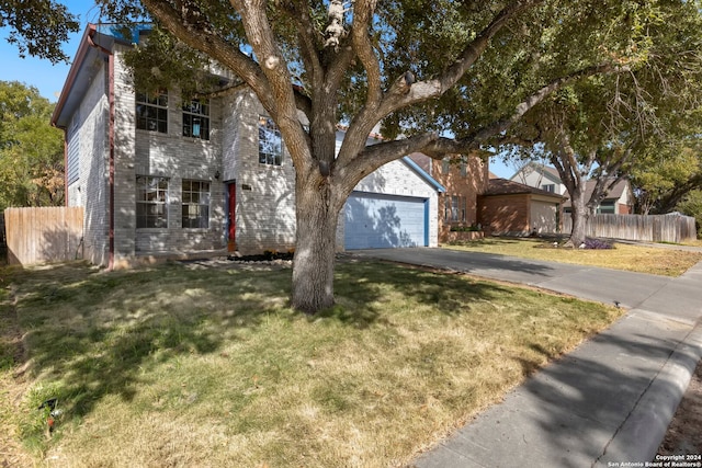 view of front of home featuring a front lawn, an outbuilding, and a garage