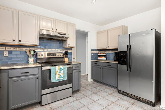 kitchen featuring gray cabinets, stainless steel appliances, backsplash, and light tile patterned floors