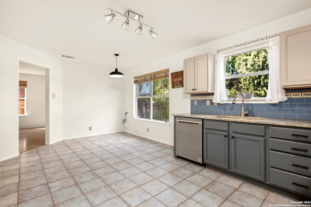 kitchen featuring gray cabinets, dishwasher, sink, and a wealth of natural light