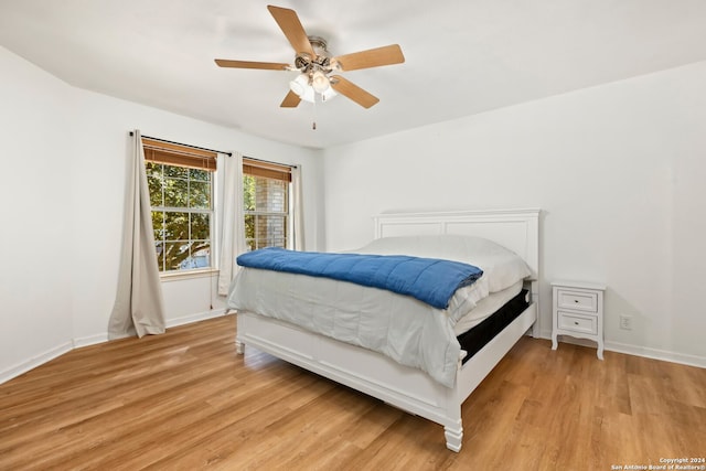 bedroom featuring light hardwood / wood-style floors and ceiling fan