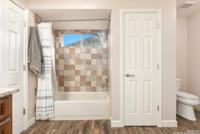 full bathroom featuring vanity, toilet, wood-type flooring, and shower / bath combo