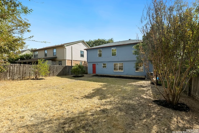 rear view of house with a yard