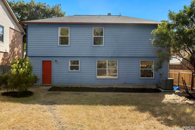 back of property with a yard and cooling unit