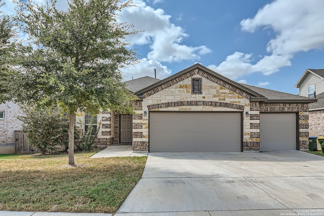 view of front of property with a front yard and a garage