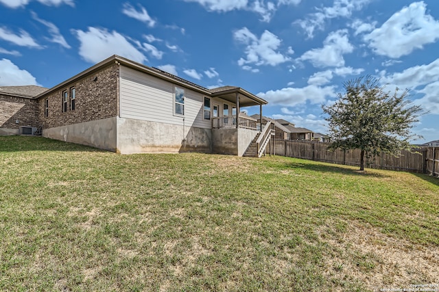 back of property with a yard and cooling unit