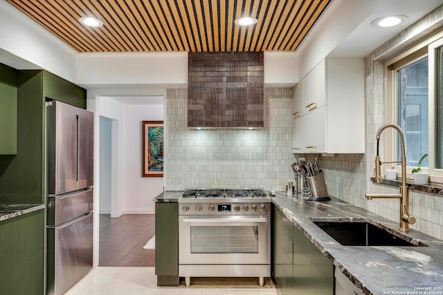 kitchen featuring hardwood / wood-style flooring, green cabinets, white cabinetry, sink, and high quality appliances