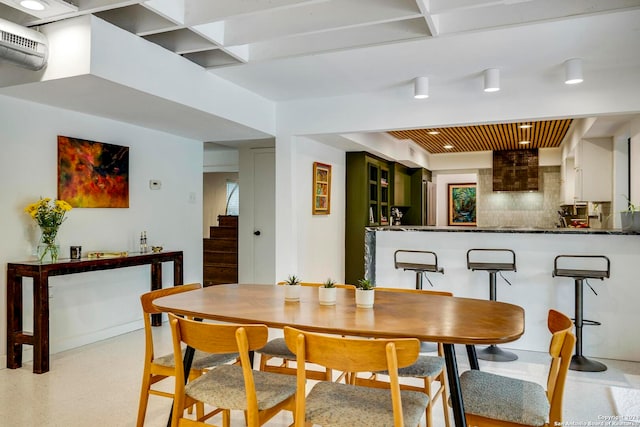 dining room featuring a wall mounted air conditioner