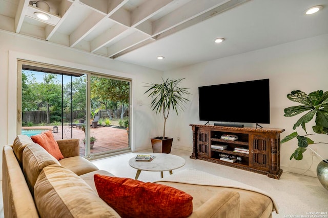 living room with beam ceiling and carpet flooring