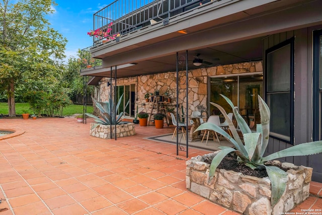 view of patio / terrace featuring ceiling fan and a balcony