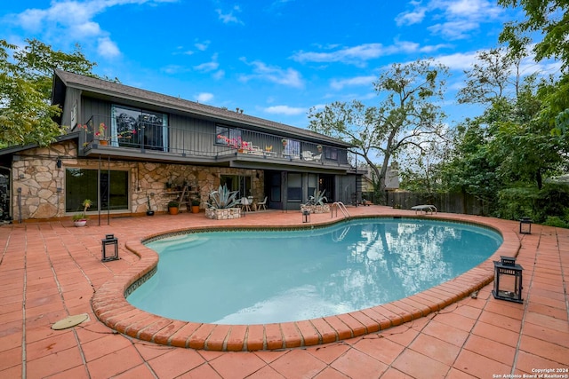 view of swimming pool with a patio area