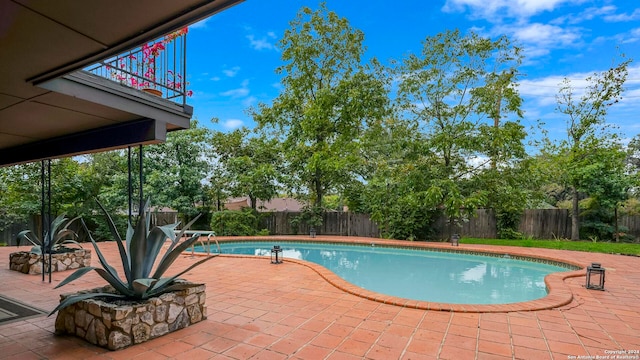 view of swimming pool with a patio