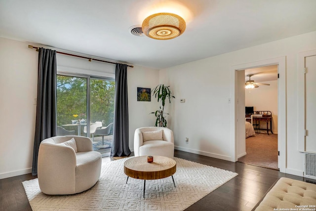 sitting room featuring dark hardwood / wood-style floors and ceiling fan