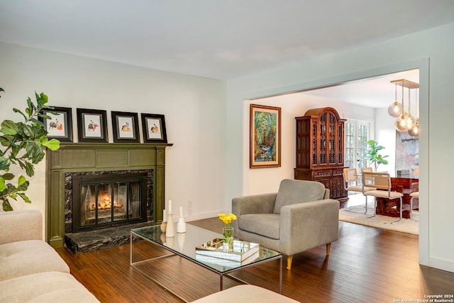 living room featuring a premium fireplace and dark hardwood / wood-style flooring