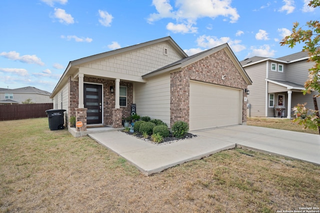 craftsman house with a front lawn and a garage