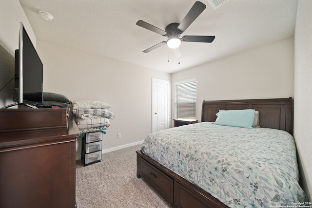 bedroom featuring light colored carpet and ceiling fan