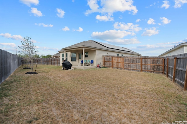 back of house featuring a yard and a patio