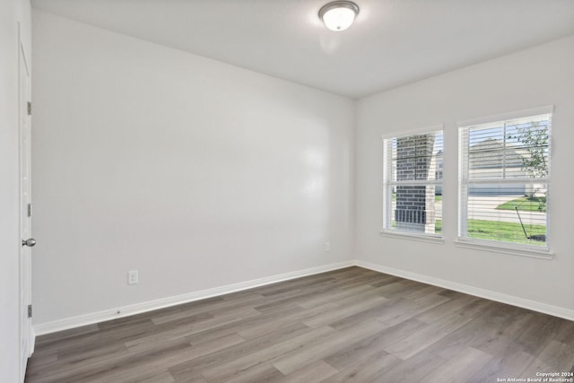 spare room with hardwood / wood-style flooring