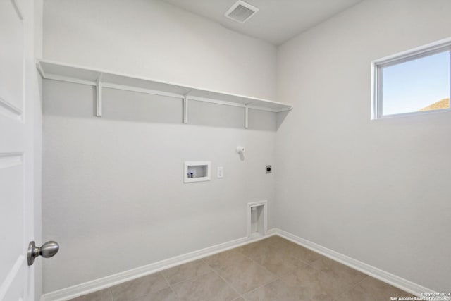 washroom with hookup for a gas dryer, hookup for a washing machine, light tile patterned flooring, and hookup for an electric dryer