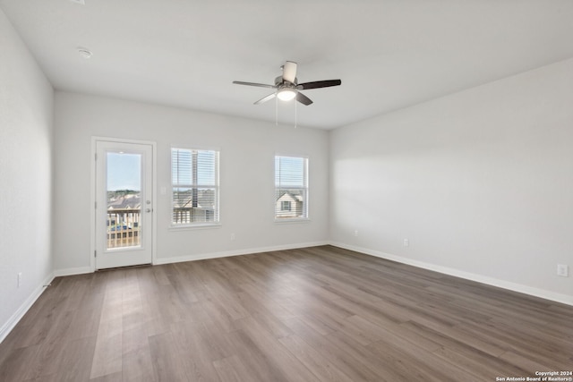 empty room featuring hardwood / wood-style flooring and ceiling fan