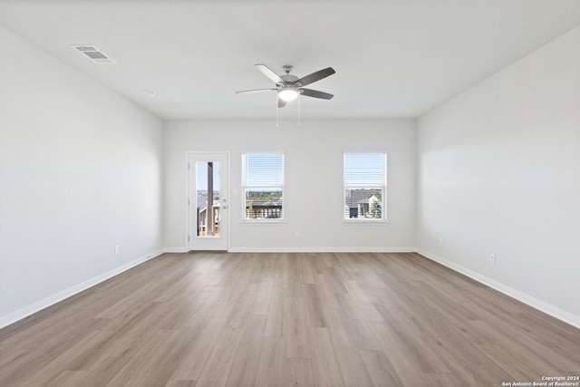 unfurnished room featuring ceiling fan and light wood-type flooring